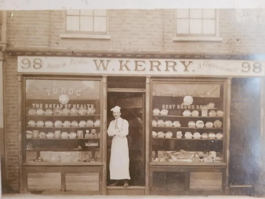 A 19th-century industrial bakery with workers preparing bread